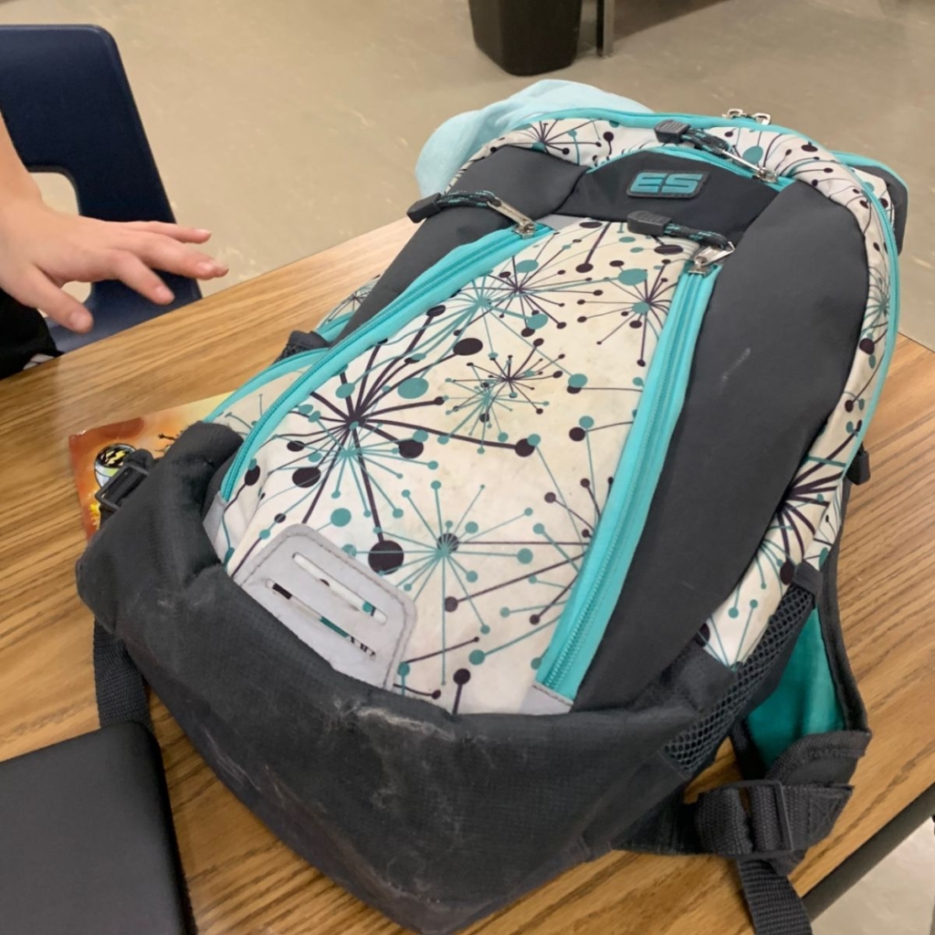 A backpack with a blue-and-turquoise network print